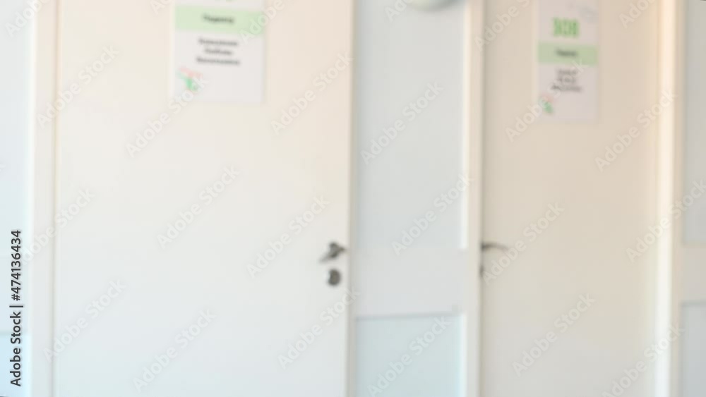 blurred image a nurse in a white coat in a polyclinic enters the office. High quality 4k footage blurred image a nurse in a white coat in a polyclinic enters the office. High quality 4k footage
