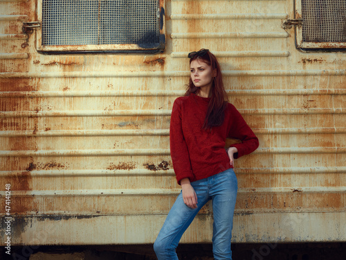 woman on near rusty trailer in the street posing