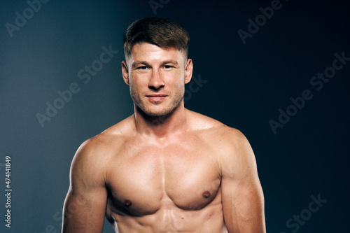 athletic male topless workout muscle bodybuilder dark background © VICHIZH