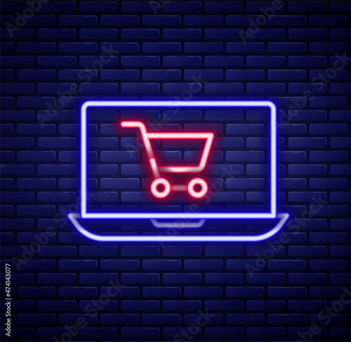 Glowing neon line Shopping cart on screen laptop icon isolated on brick wall background. Concept e-commerce, e-business, online business marketing. Colorful outline concept. Vector © Iryna