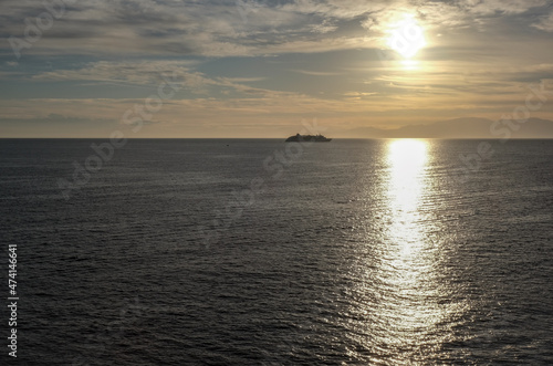 Silhouette of Hapag luxury Europa 2 cruiseship cruise ship liner yacht at sea during twilight sunrise horizon cruising towards port of Palermo, Sicily Italy during Mediterranean cruising photo