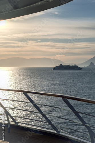 Silhouette of Hapag luxury Europa 2 cruiseship cruise ship liner yacht at sea during twilight sunrise horizon cruising towards port of Palermo, Sicily Italy during Mediterranean cruising photo