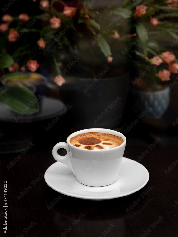 Coffee latte art in white coffee cup on dark table background and copy space Coffee latte art in white coffee cup on dark table background and copy space
