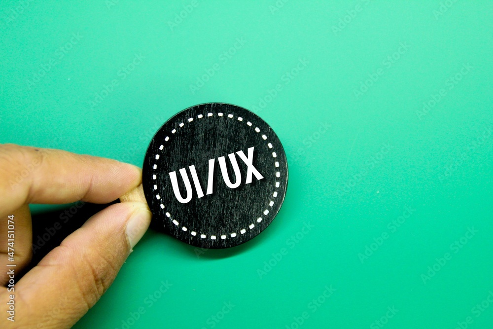 hand holding a circle with the words UI and UX letters or User ...