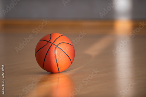 Basketball on hardwood court floor with natural lighting. Workout online concept, Horizontal sport theme poster, greeting cards, headers, website and app © Augustas Cetkauskas