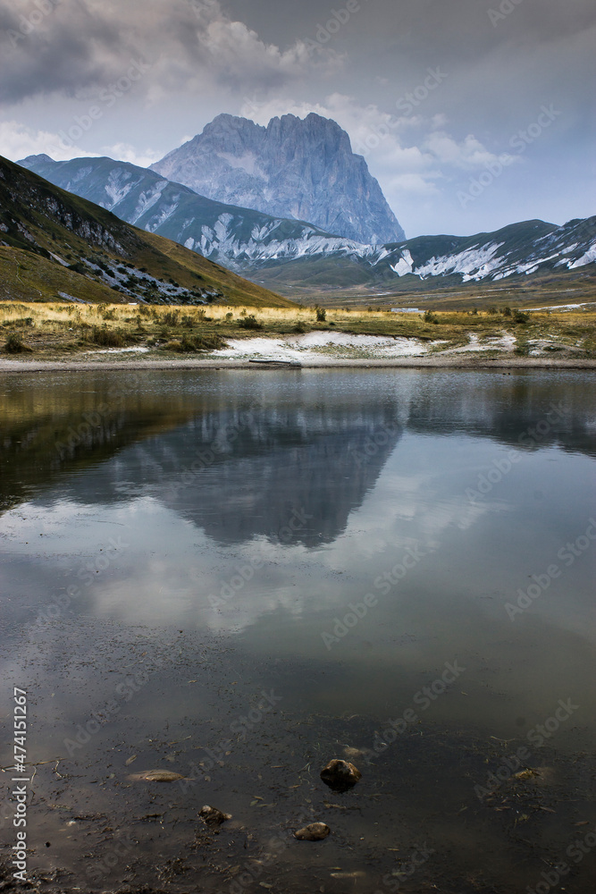 view of lake in Abruzzo with Gran Sasso mountain in background