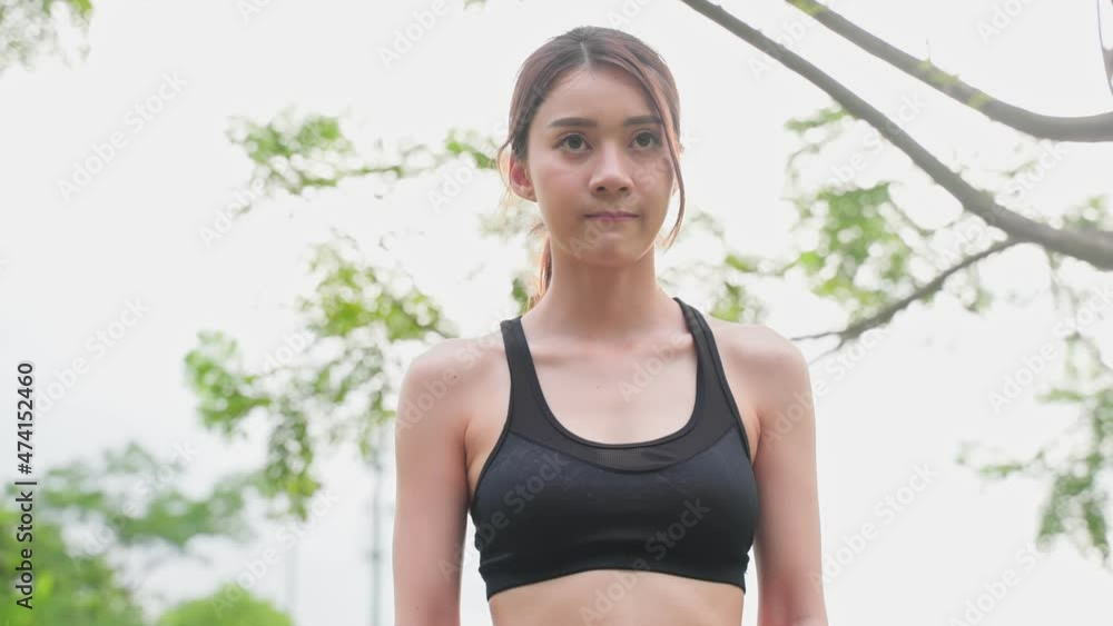 Asian young beautiful sport woman running on street in public park. Asian young beautiful sport woman running on street in public park.