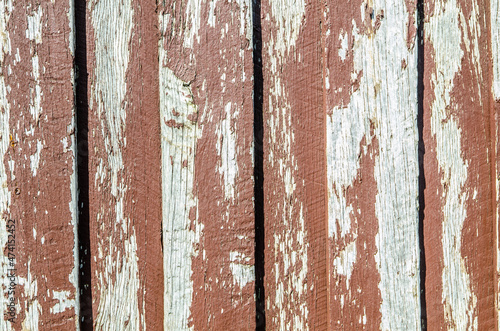 Peeling old red paint on timber wall background. © arliftatoz2205