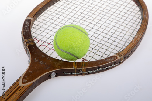 Old vintage wooden tennis racket and yellow ball closeup © OceanProd