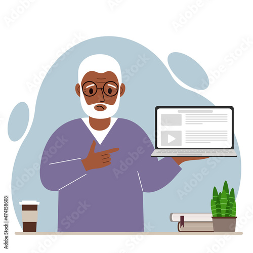 Sad grandfather holding a laptop computer with one hand and pointing at it with the other. Laptop computer technology concept.