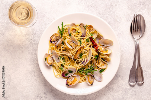 Seafood pasta with clams Spaghetti alle Vongole on a light background photo