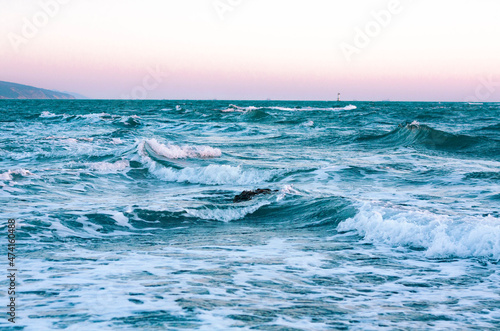 Blue foamy sea waves on the beach