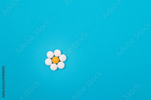 Global Pharmaceutical Industry and Medicinal Products - White Pills or Tablets Lying on Blue Background