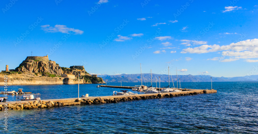 Corfu Castle old fort Greek island surrounded by blue sea sky and mountains a tourist attraction in Mediterranean Greece.