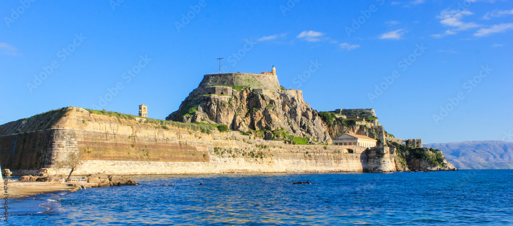 Corfu Castle old fort Greek island surrounded by blue sea sky and mountains a tourist attraction in Mediterranean Greece.
