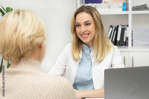 Woman doctor and patient are discussing something, sitting at the table. Medicine and healthcare concept. Health insurance. Doctor and patient