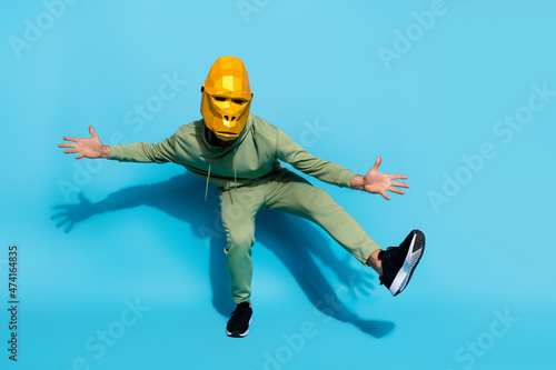 Photo of freak weird funky entertainer dance wear gorilla mask sportswear footwear isolated blue color background