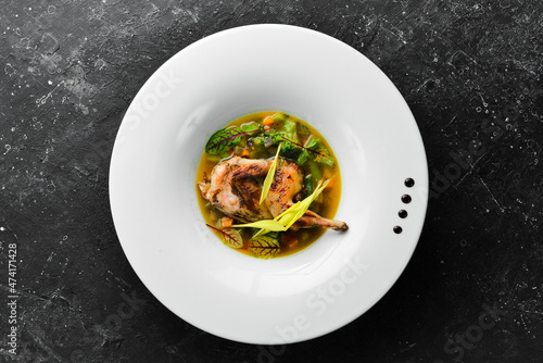 Quail meat soup with vegetables and spices. Restaurant menu. top view. Free space for text