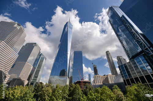 One World Trade Center skyscraper office building in Manhattan, New York, in a sunny day with blue sky and amazing reflections. One of the best sights and landmarks in America.
