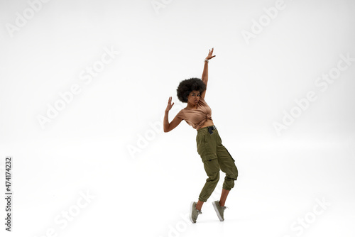 фотографія Black woman dancing hip hop on white background