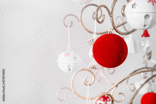 Red velvet Christmas bauble and white ornaments in metallic tree