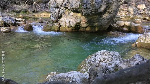 Mountain river flowing among large stones 