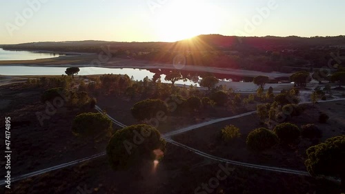 Wallpaper Mural Drone footage over the river, trees, and dirt roads. Sunset cinematic shot towards the sun. Torontodigital.ca