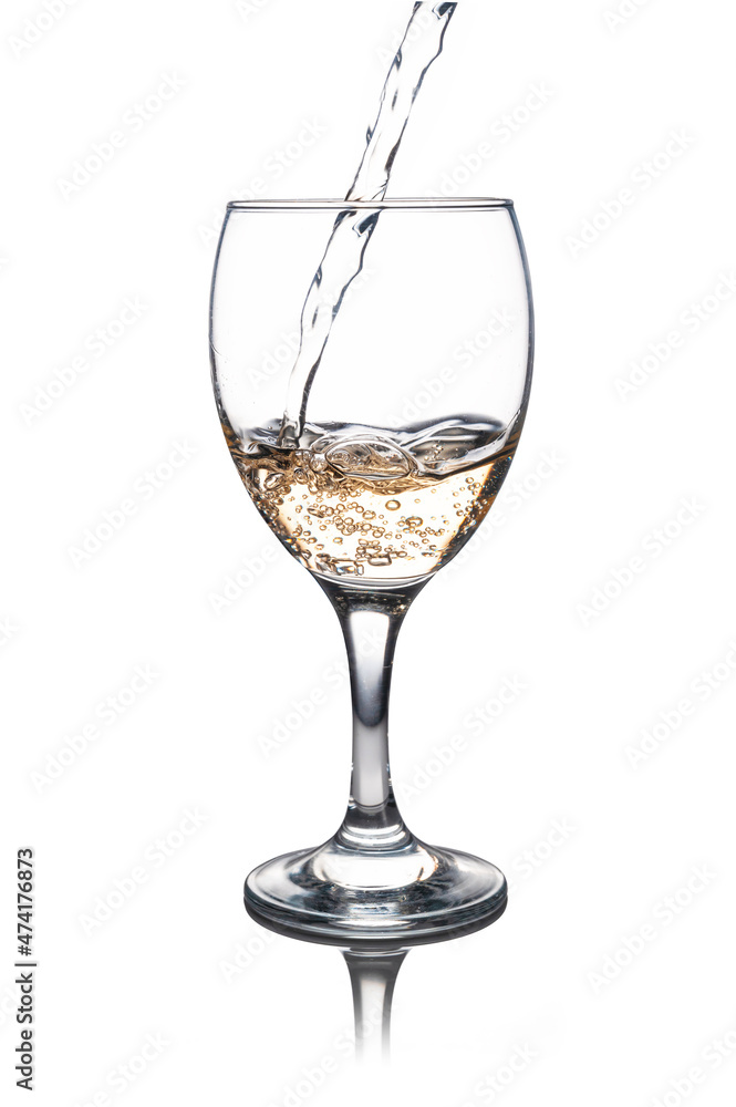 Glass with white wine filling up, isolated from the background Glass with white wine filling up, isolated from the background