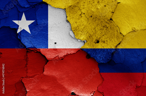 flags of Chile and Colombia painted on cracked wall