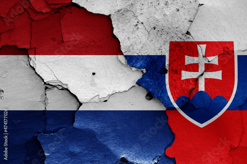 flags of Netherlands and Slovakia painted on cracked wall