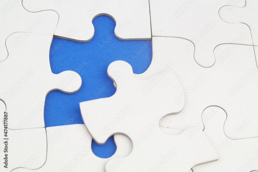 White jigsaw puzzles background, one piece missing and ready to connecting. Business strategy, teamwork, problem solving and complete mission concept. White jigsaw puzzles background, one piece missing and ready to connecting. Business strategy, teamwork, problem solving and complete mission concept.
