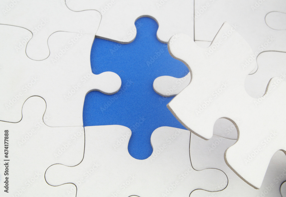 White jigsaw puzzles background, one piece missing and ready to connecting. Business strategy, teamwork, problem solving and complete mission concept. White jigsaw puzzles background, one piece missing and ready to connecting. Business strategy, teamwork, problem solving and complete mission concept.