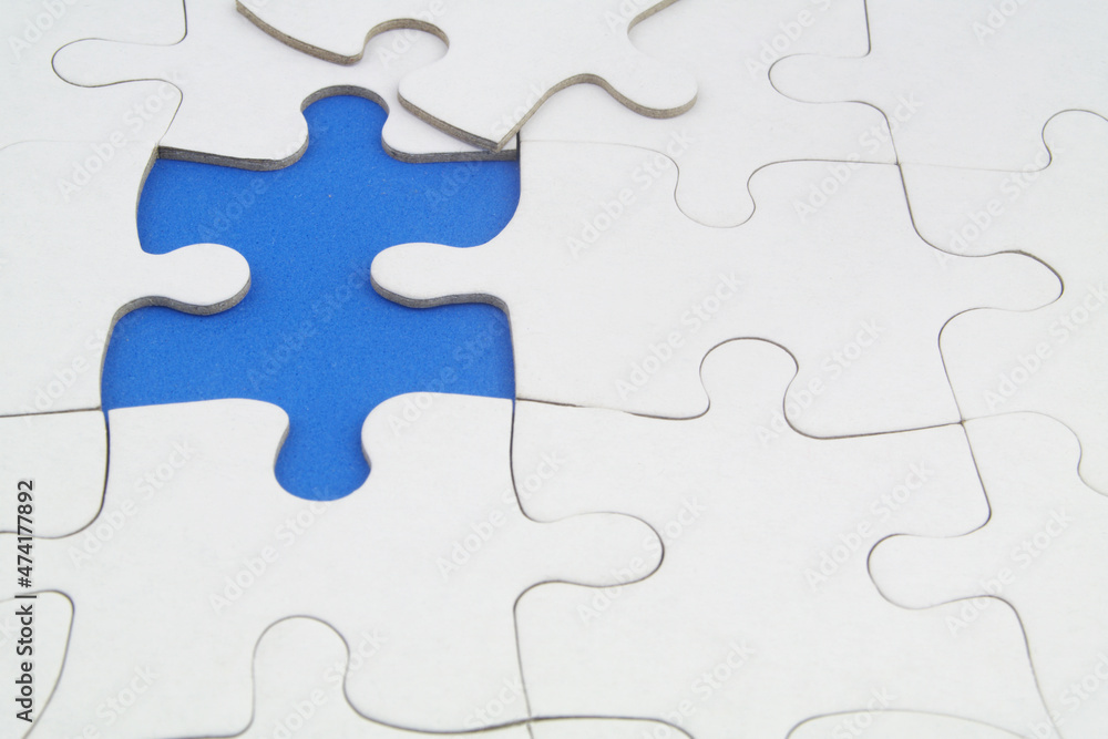 White puzzles background, one piece missing and ready to connecting. Business strategy, team work, problem solving and complete mission concept. White puzzles background, one piece missing and ready to connecting. Business strategy, team work, problem solving and complete mission concept.
