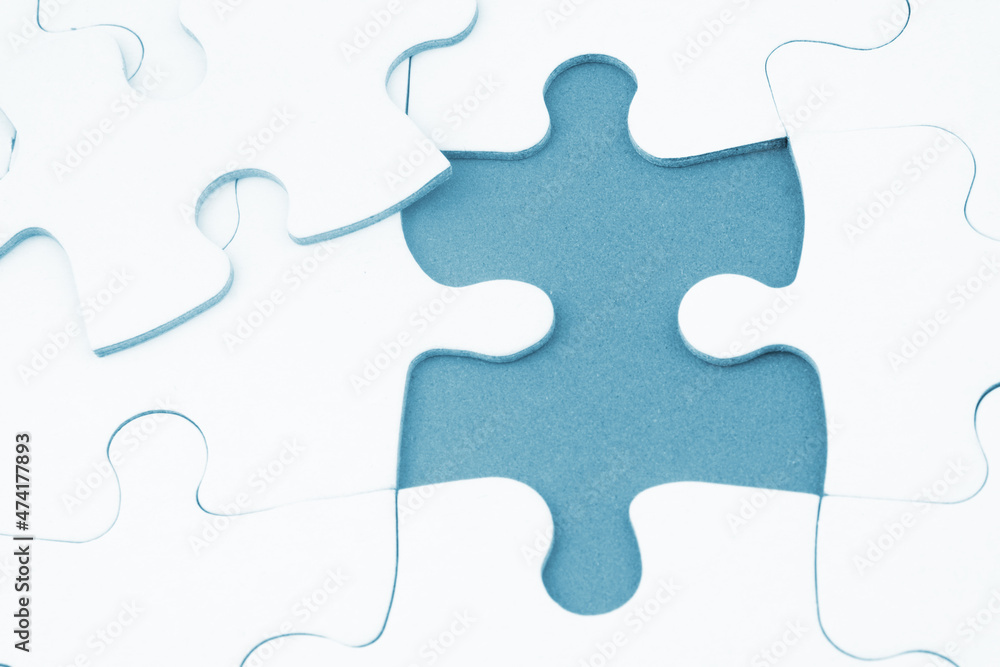 White jigsaw puzzles background, one piece missing and ready to connecting. Business strategy, teamwork, problem solving and complete mission concept. White jigsaw puzzles background, one piece missing and ready to connecting. Business strategy, teamwork, problem solving and complete mission concept.
