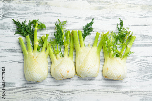 Organic fennel on a white wooden background. Healthy food. Top view. Free space for your text.