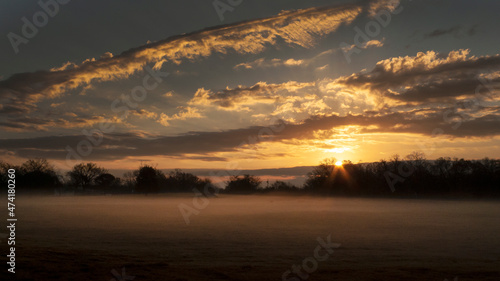Sunrise panorama with cloudscape, sunbeams and fog © Tamara  Harding