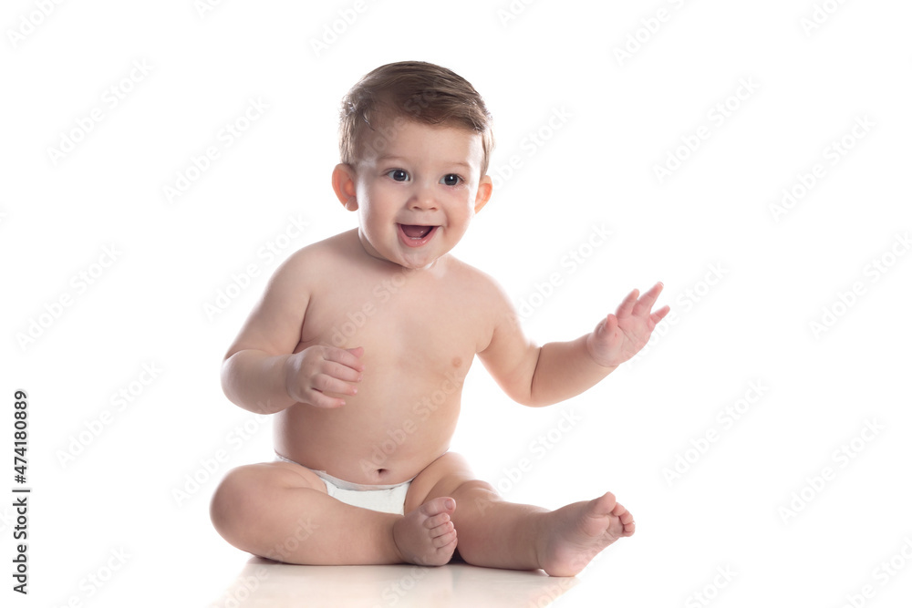 Cute baby in diaper looking at the camera Cute baby in diaper looking at the camera