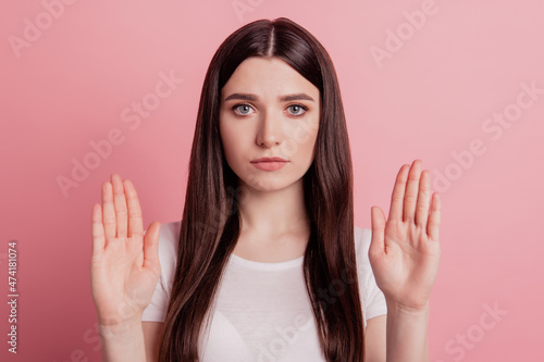 Portrait of serious strict girl show palms no stop sign reject refuse forbidden isolated over pastel color background