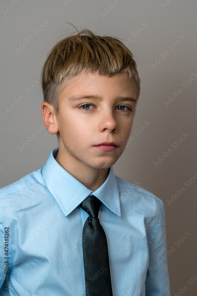 Portrait of confident school kid boy in blue shirt with black tie Portrait of confident school kid boy in blue shirt with black tie