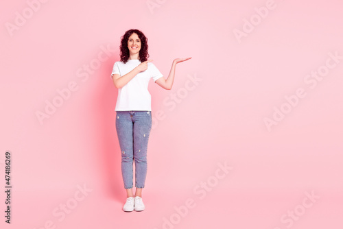 Full body photo of young girl indicate finger product offer advertise isolated over pink color background