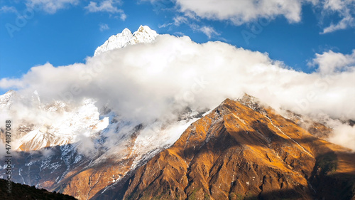 Mountain everest snow white cold freeze top of the world blue skies cloud shadow beautiful amazing view brown rock drone aerial chomolungma nepal tibet 