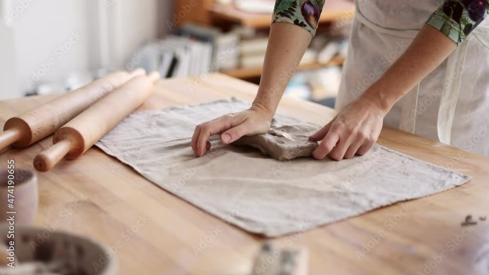 Artist's hands working in pottery workshop Artist's hands working in pottery workshop