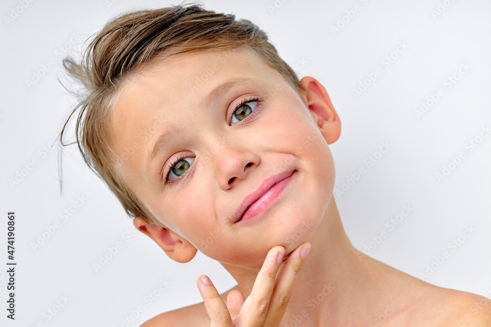 Happy, smiley little caucasian boy isolated on white studio background with copyspace for ad. Looks happy, cheerful, touching clean facial skin.Childhood, human emotions, facial expression concept. Happy, smiley little caucasian boy isolated on white studio background with copyspace for ad. Looks happy, cheerful, touching clean facial skin.Childhood, human emotions, facial expression concept.