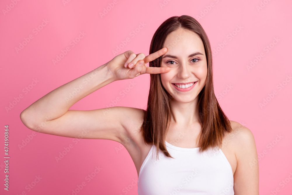 Photo of youth lovely girl cheerful fooling playful show peace coo v-symbol isolated over pink color background Photo of youth lovely girl cheerful fooling playful show peace coo v-symbol isolated over pink color background