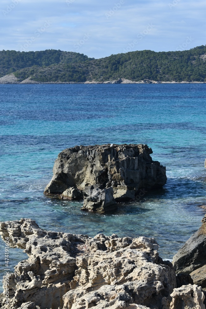 Fototapeta premium Rocks, the sea and mountains in a National Park called Las Salinas in Ibiza