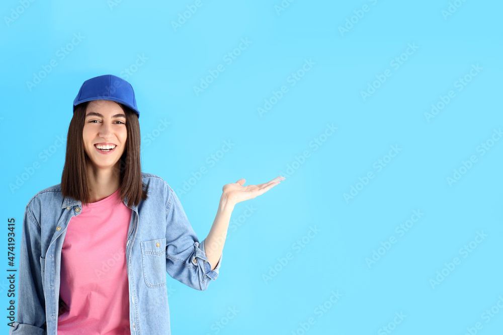Attractive girl in cap on blue background Attractive girl in cap on blue background