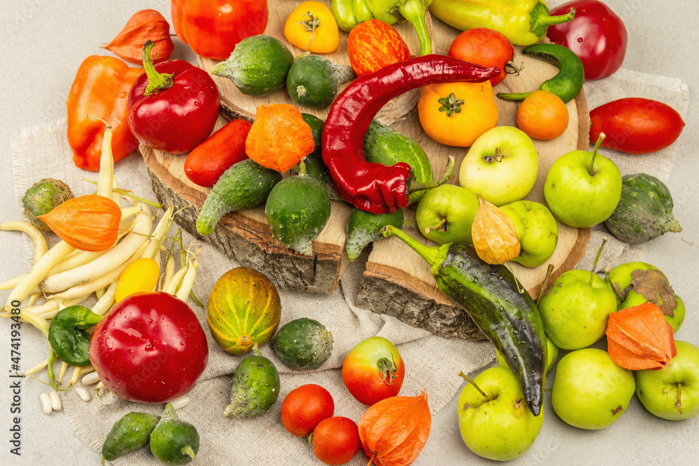 Trendy ugly organic vegetables and fruits on stone concrete background