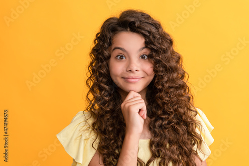 smiling teen girl with long curly hair and perfect skin, beauty