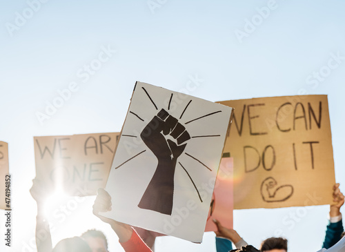 People standing with posters with inscription Black Lives Matter on meeting photo