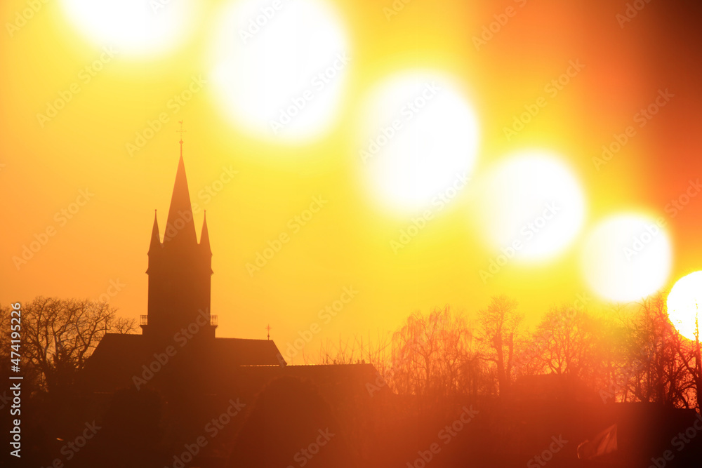 Sunset over church silhouette, shot with a special timeslice technique